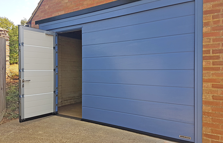Hormann Sectional Garage Door with Wicket Door in Pigeon Blue